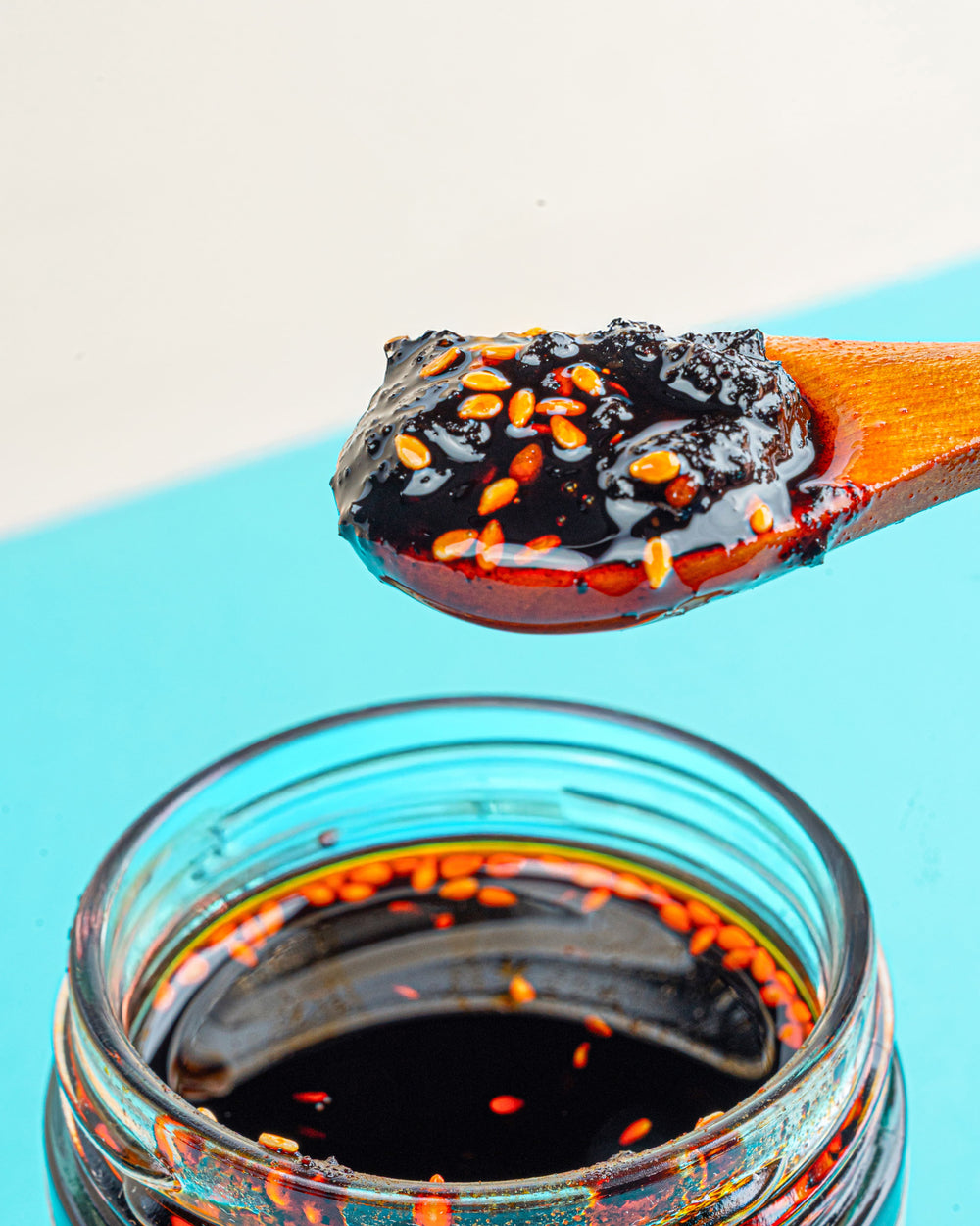 Close-up of a spoonful of Veracruz All Natural Peanut Macha showing its nutty, crunchy chili oil texture with peanuts and seeds