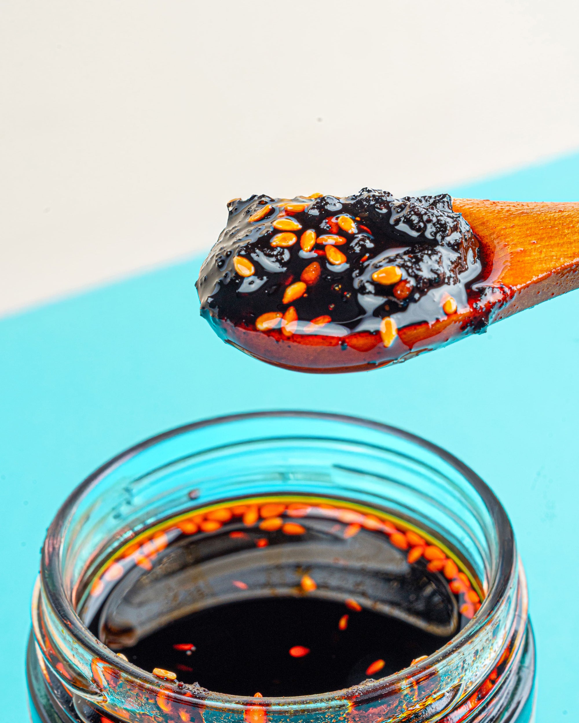 Close-up of a spoonful of Veracruz All Natural Peanut Macha showing its nutty, crunchy chili oil texture with peanuts and seeds